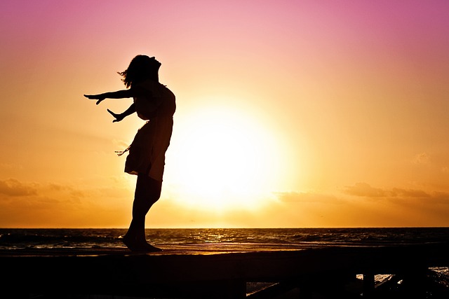 women jumping next to sun